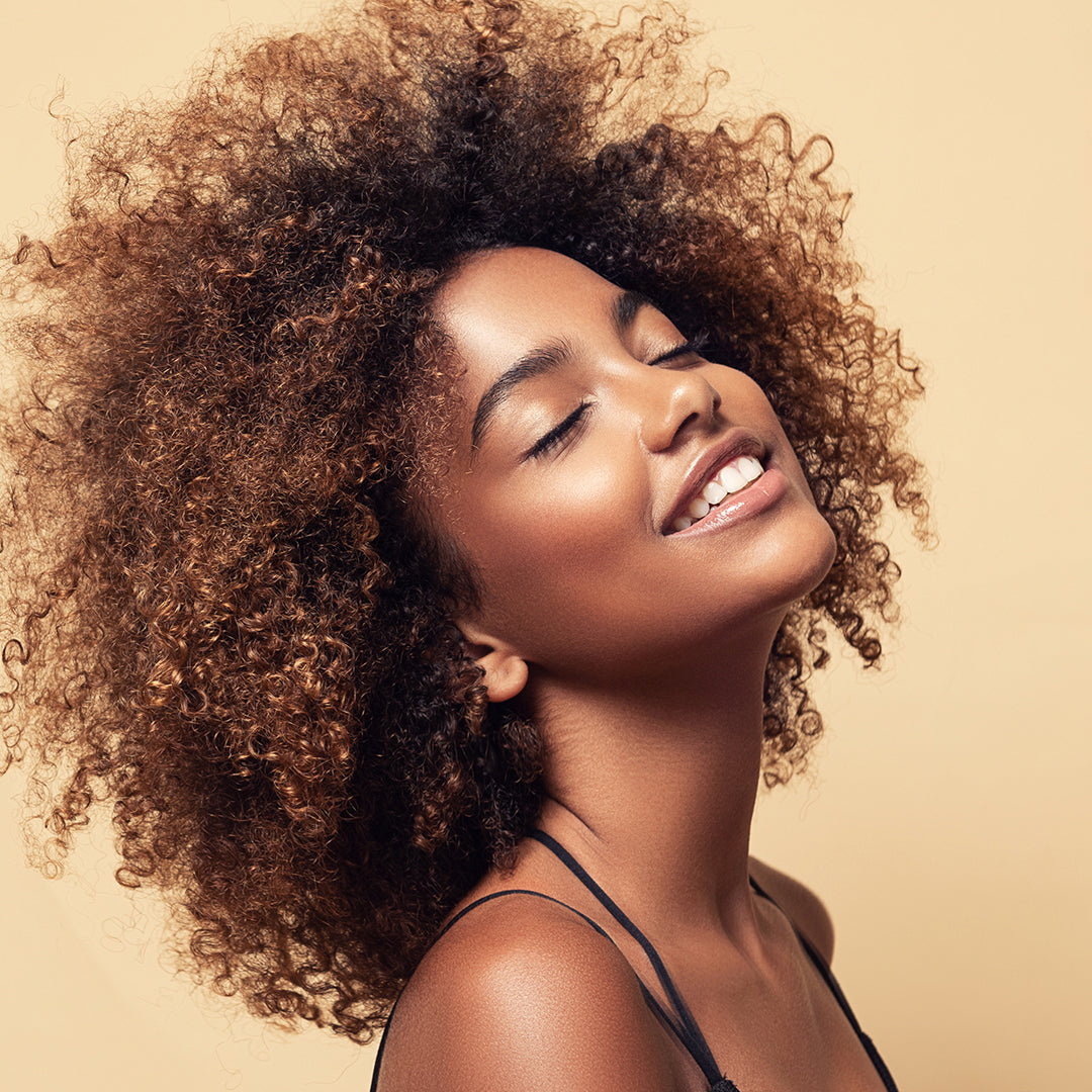 Image of model with big curly, healthy, young looking hair