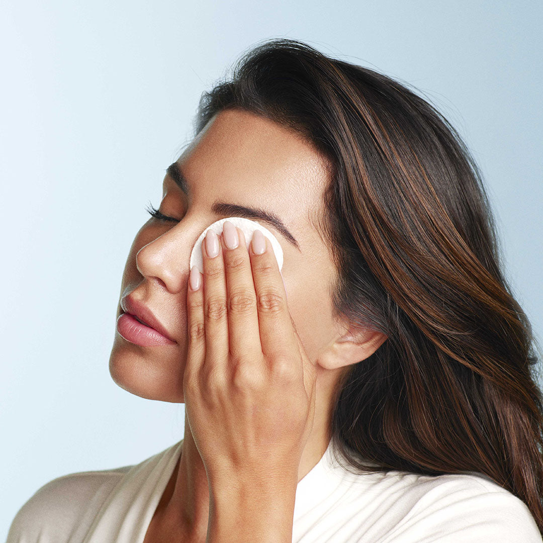 Image of model removing makeup with a cotton pad